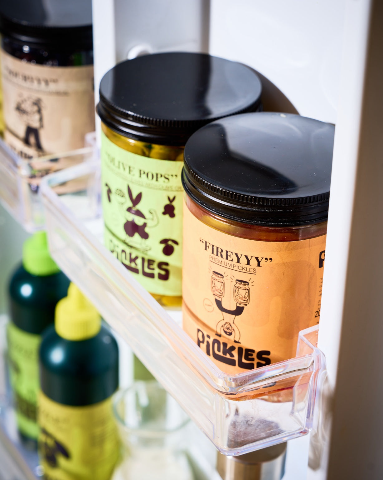 Pickles Olive Gang jars arranged inside a refrigerator