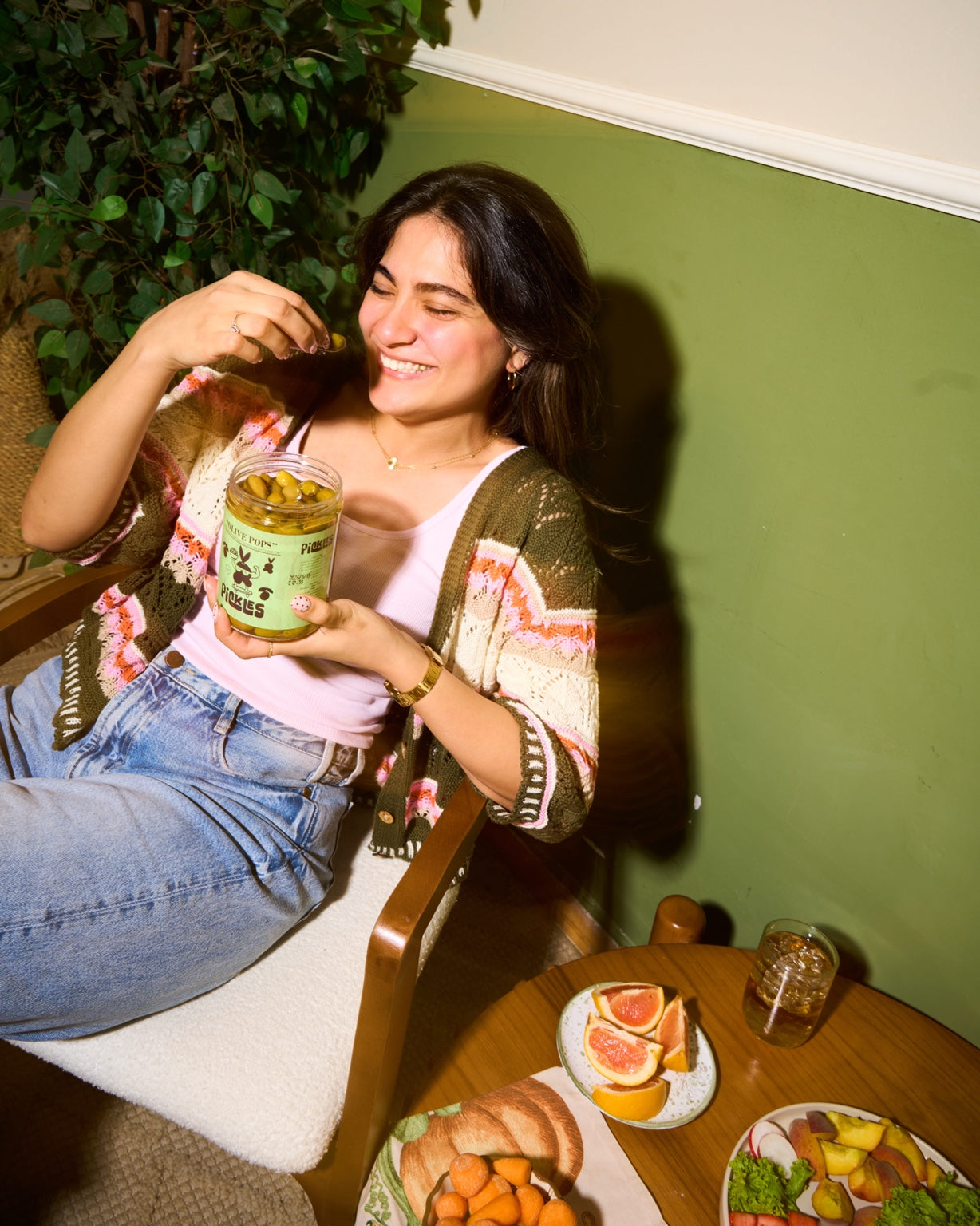 Woman enjoying Pickles Olive Pops green olives